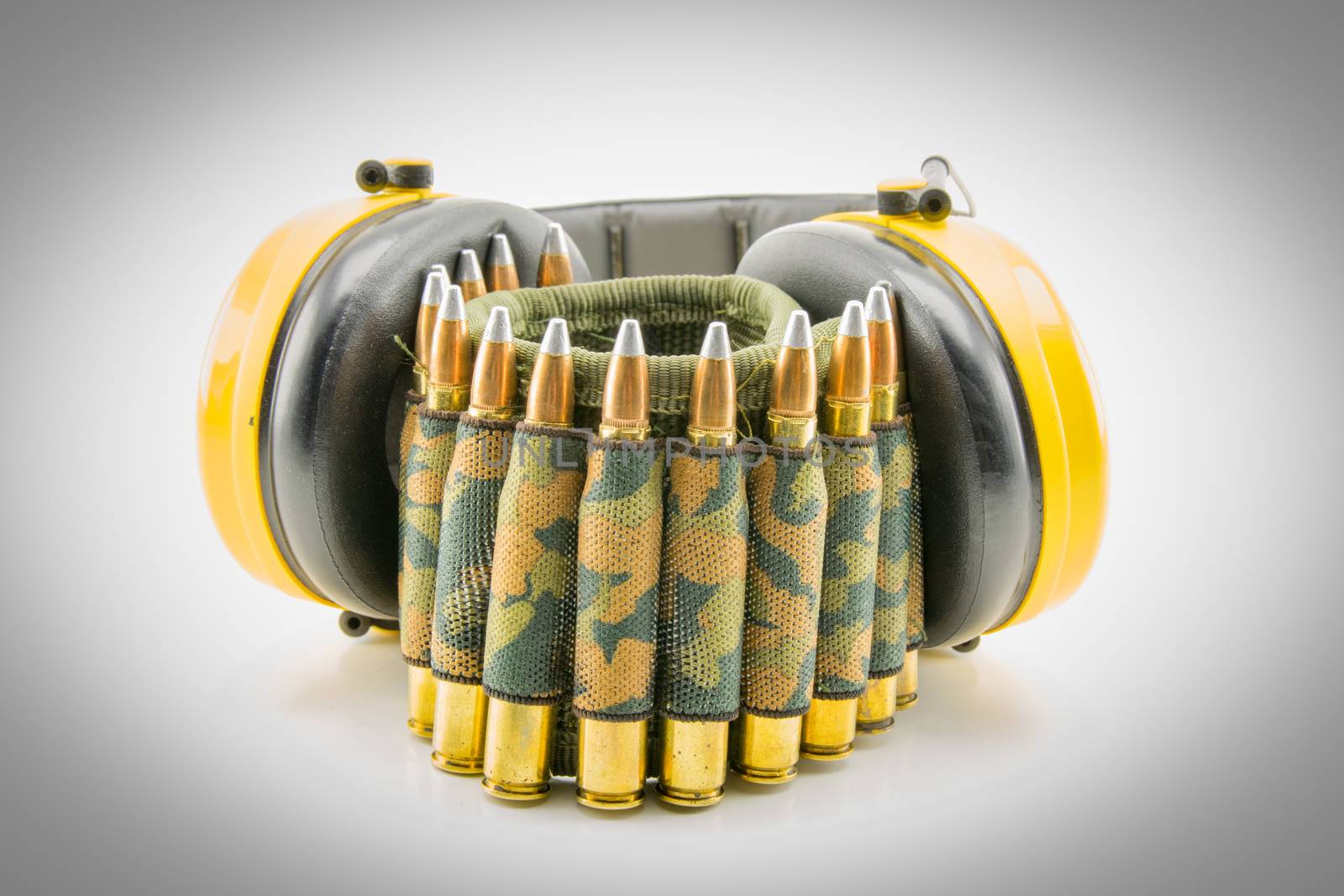 yellow ear protection and camouflage ammunition belt for rifle