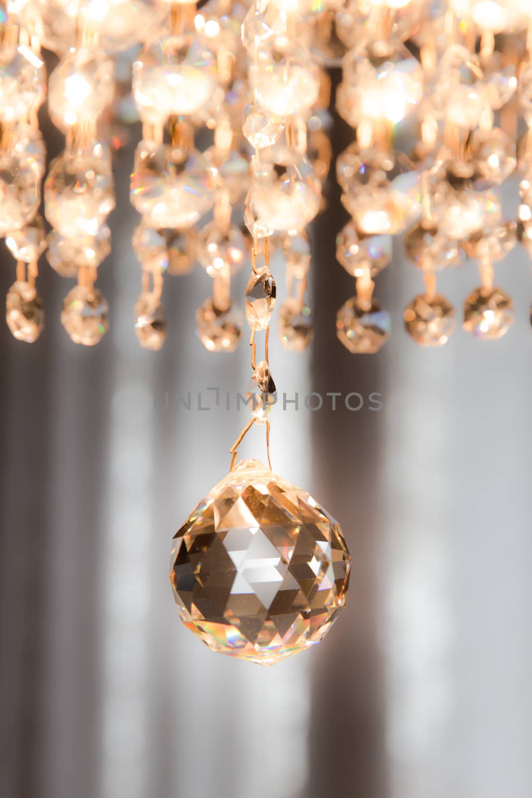 detail of a crystal chandelier that shines with warm light