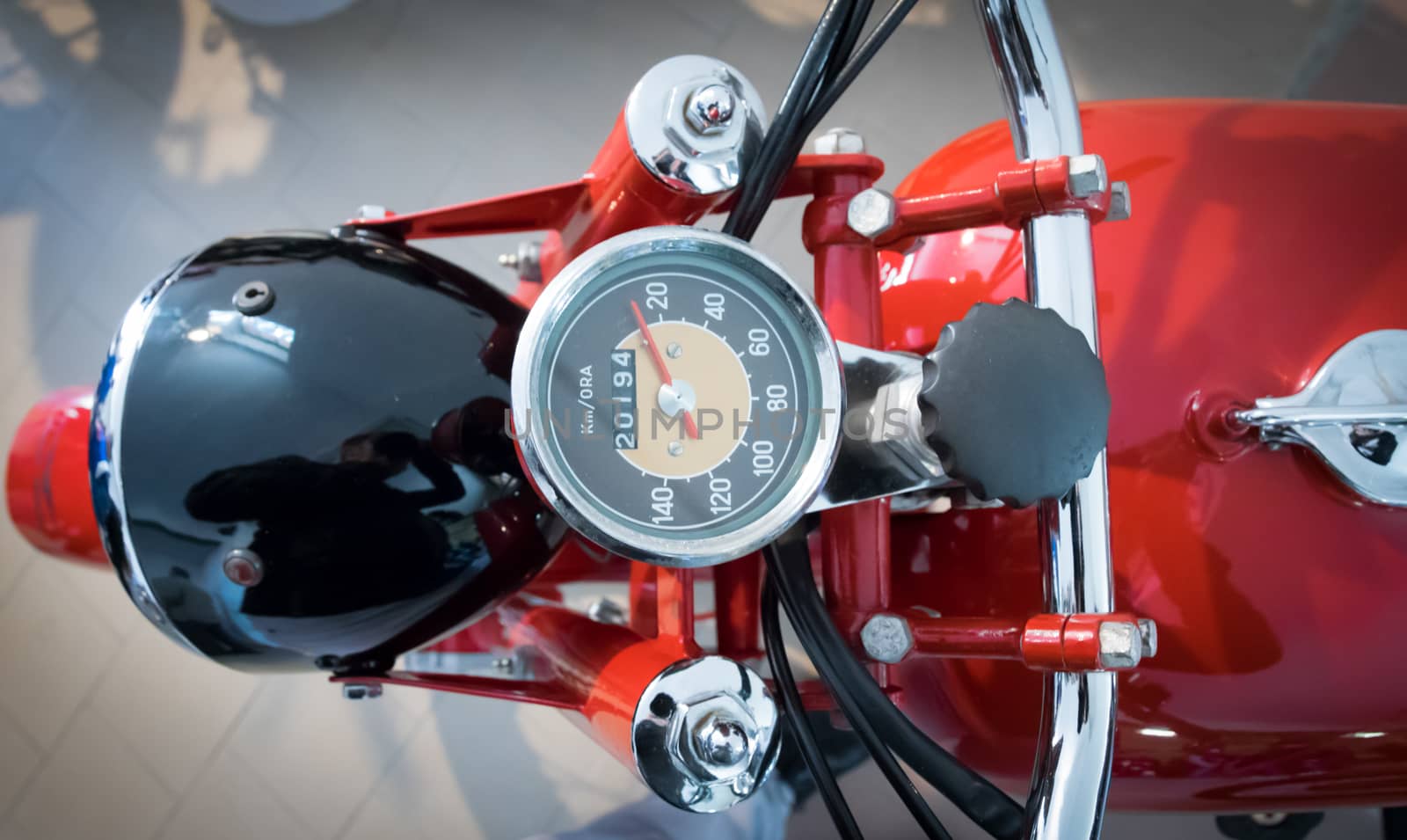 speedometer of a vintage red motorcycle