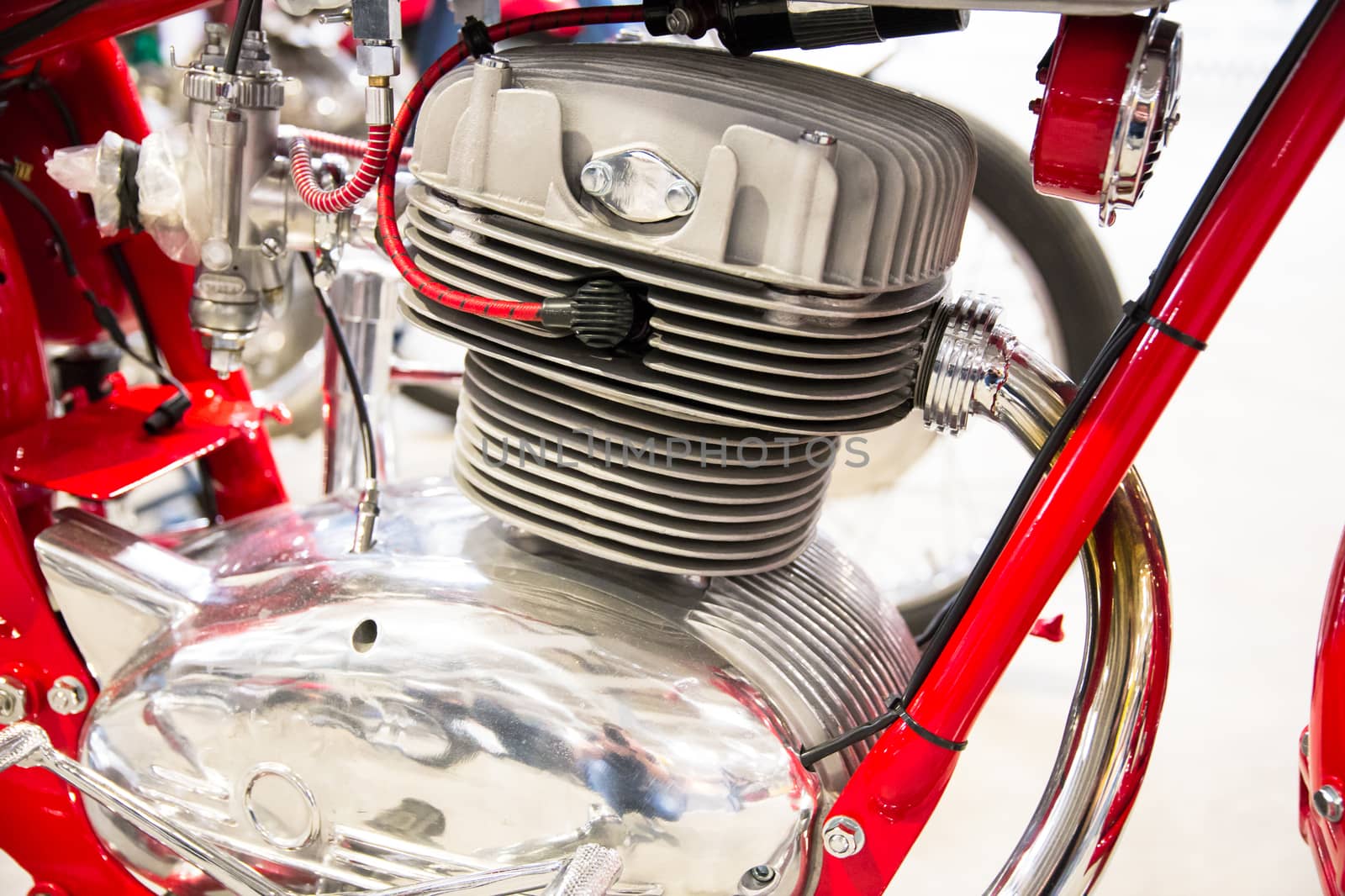 detail of the head of the engine of a red vintage motorcycles