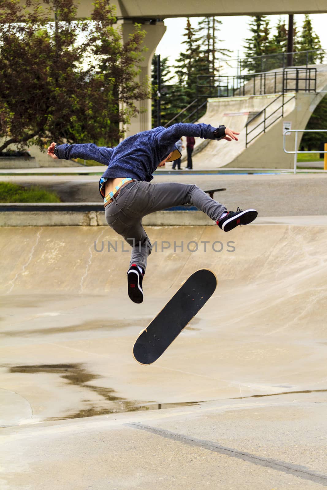 CALGARY, CANADA - JUN 21, 2015: Athletes have a friendly skateboard competition in Calgary. California law requires anyone under the age of 18 to wear a helmet while riding a skateboard.