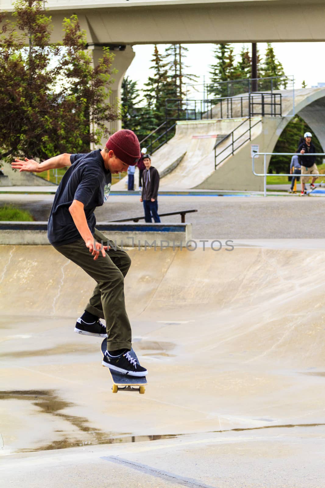 CALGARY, CANADA - JUN 21, 2015: Athletes have a friendly skateboard competition in Calgary. California law requires anyone under the age of 18 to wear a helmet while riding a skateboard.