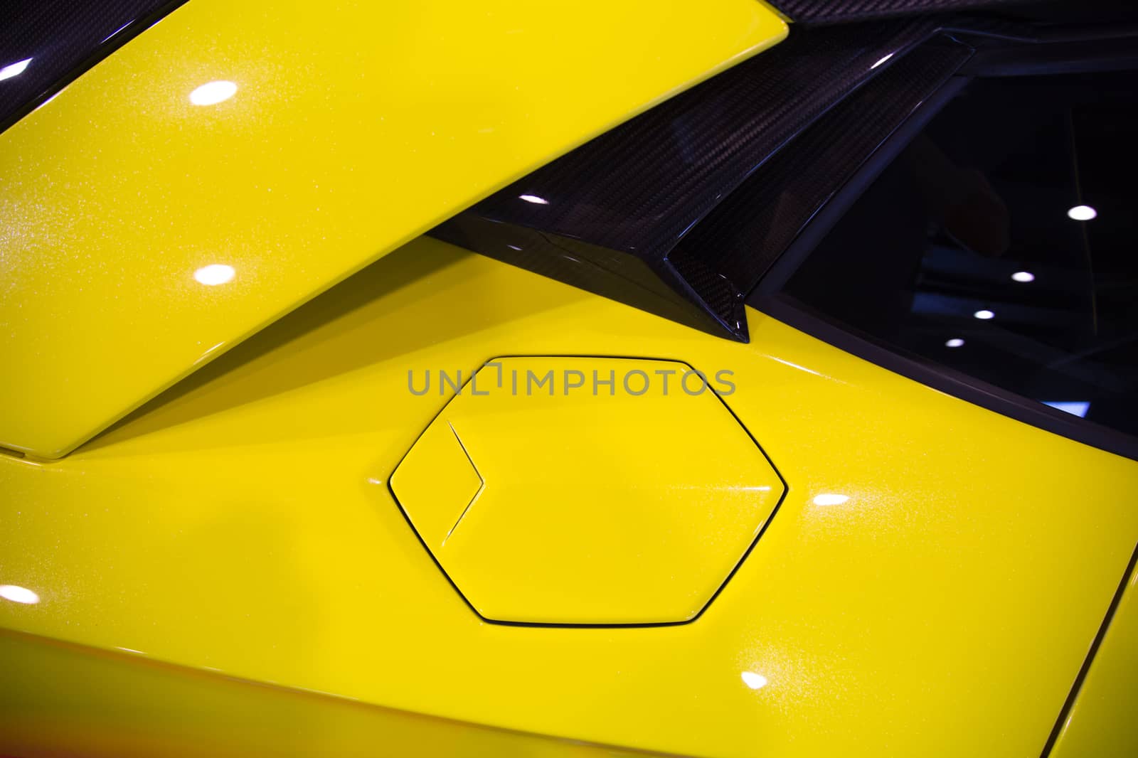 hexagonal fuel cap of a yellow sportscar