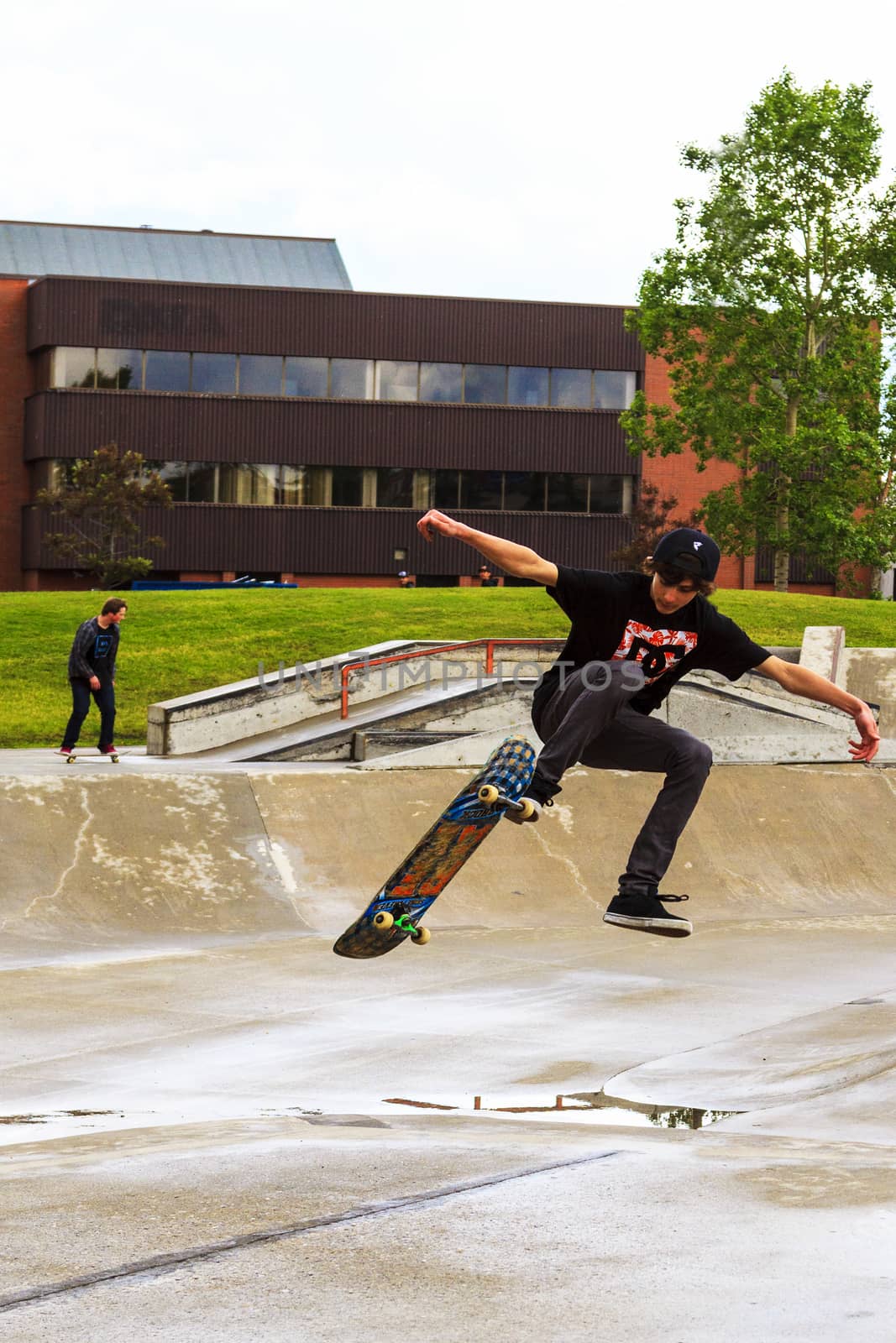 CALGARY, CANADA - JUN 21, 2015: Athletes have a friendly skateboard competition in Calgary. California law requires anyone under the age of 18 to wear a helmet while riding a skateboard.