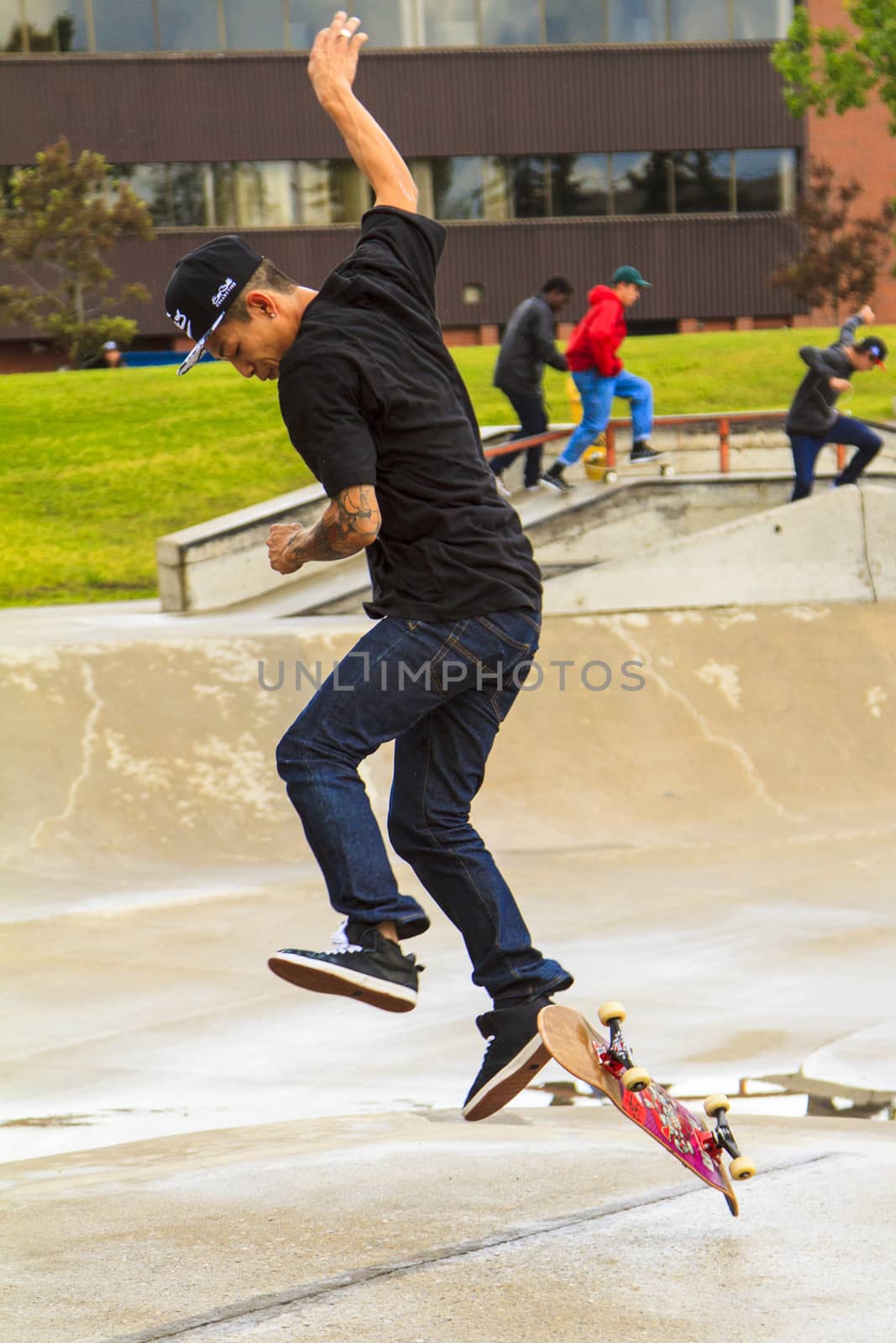 CALGARY, CANADA - JUN 21, 2015: Athletes have a friendly skateboard competition in Calgary. California law requires anyone under the age of 18 to wear a helmet while riding a skateboard.