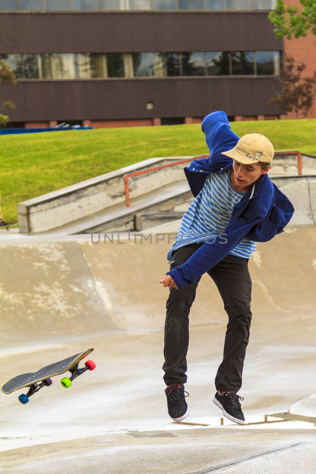 CALGARY, CANADA - JUN 21, 2015: Athletes have a friendly skateboard competition in Calgary. California law requires anyone under the age of 18 to wear a helmet while riding a skateboard.