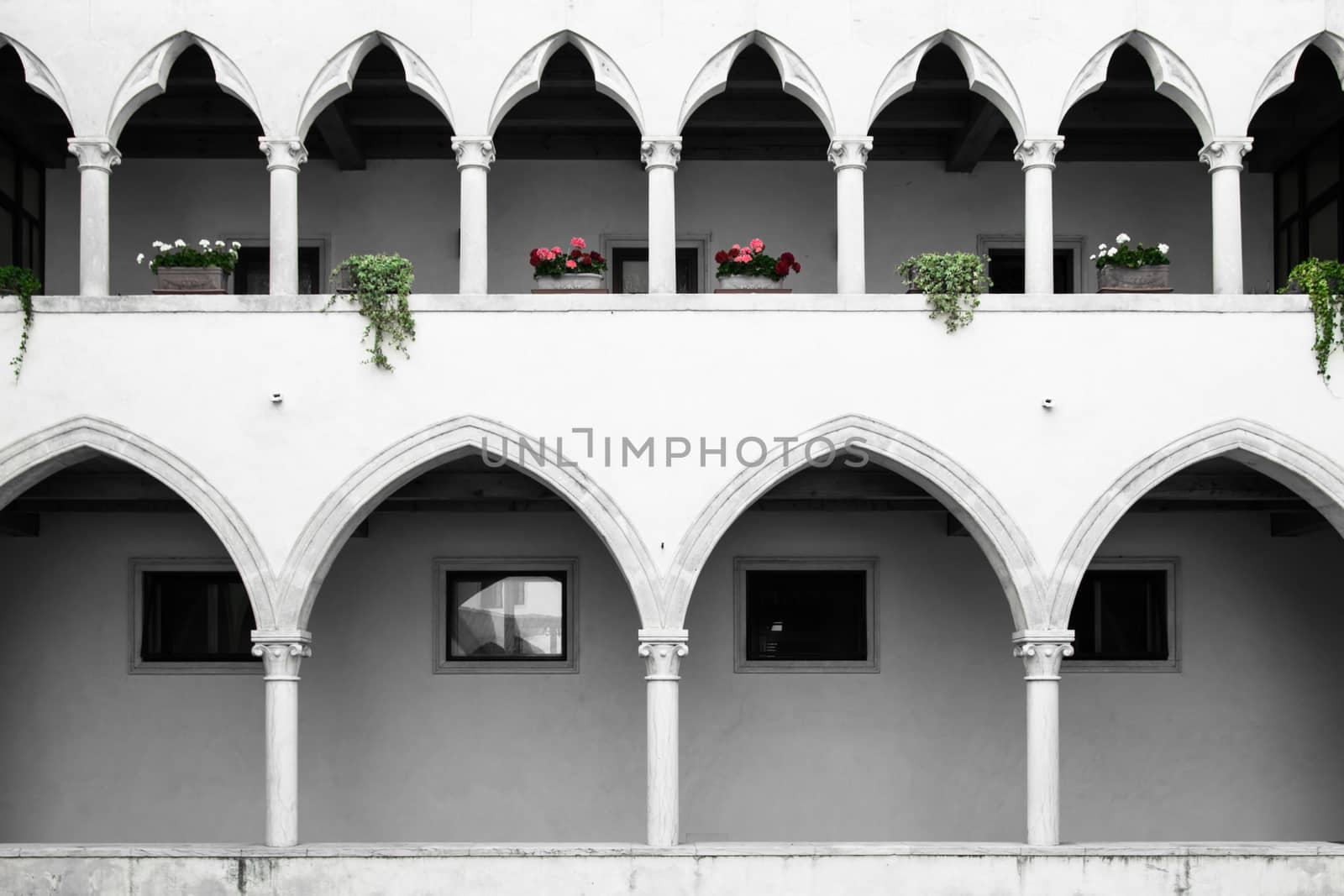 rectangular cloister with Gothic arches and marble columns. On the first floor a lovely loggia with gothic arches trefoil.