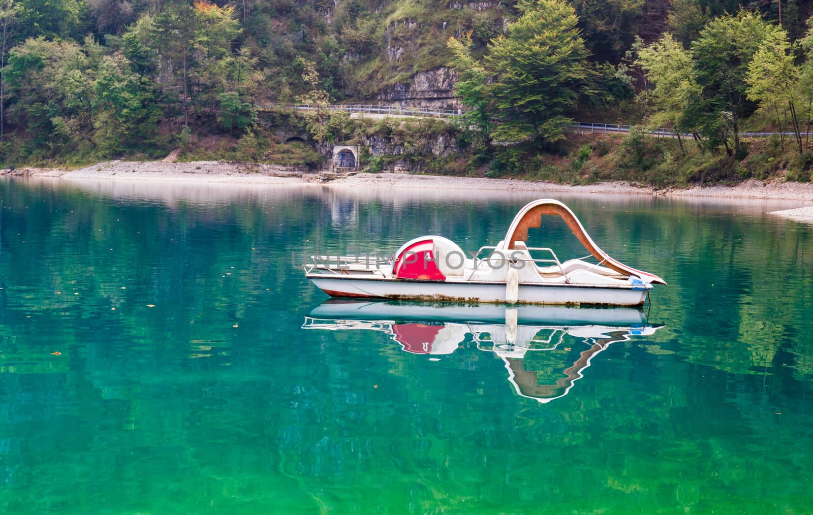 pedal boat abandoned on the calm water of the lake