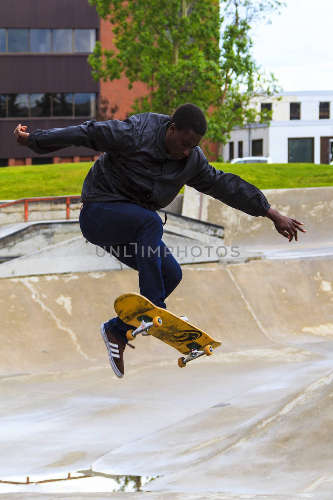 CALGARY, CANADA - JUN 21, 2015: Athletes have a friendly skateboard competition in Calgary. California law requires anyone under the age of 18 to wear a helmet while riding a skateboard.