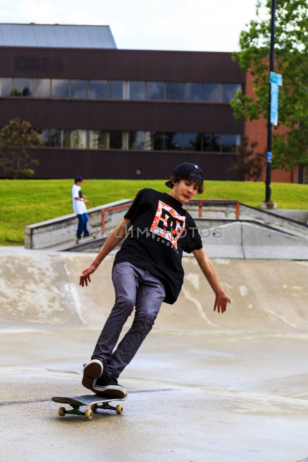 CALGARY, CANADA - JUN 21, 2015: Athletes have a friendly skateboard competition in Calgary. California law requires anyone under the age of 18 to wear a helmet while riding a skateboard.