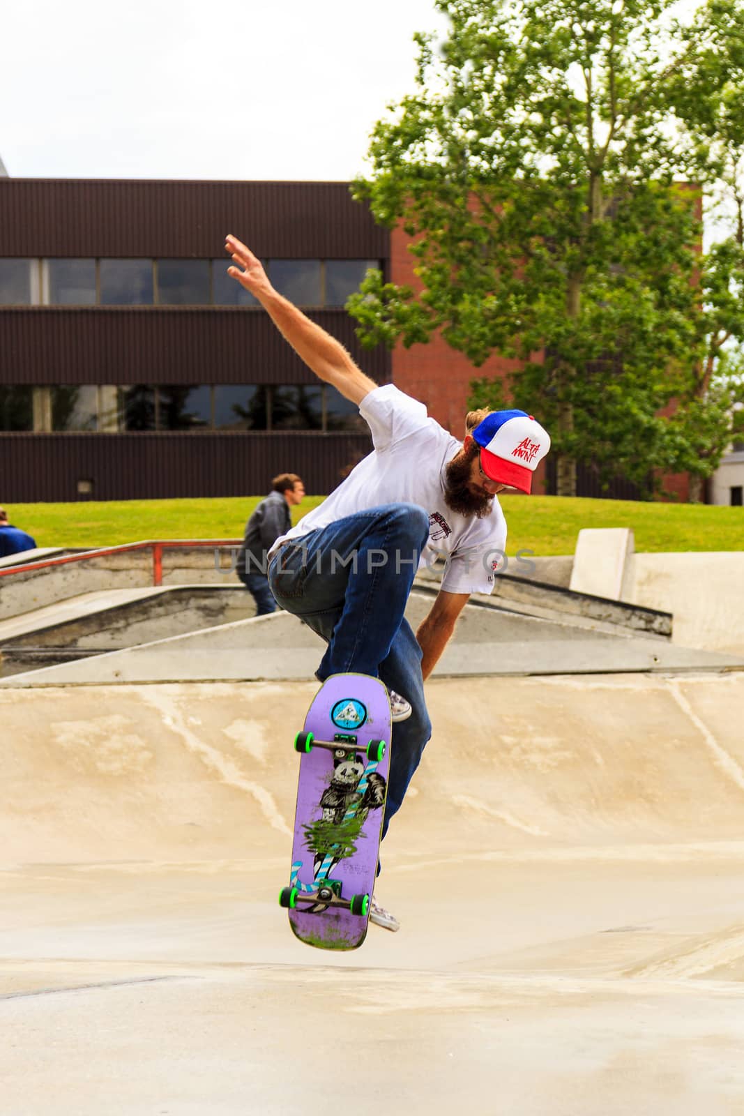 CALGARY, CANADA - JUN 21, 2015: Athletes have a friendly skateboard competition in Calgary. California law requires anyone under the age of 18 to wear a helmet while riding a skateboard.