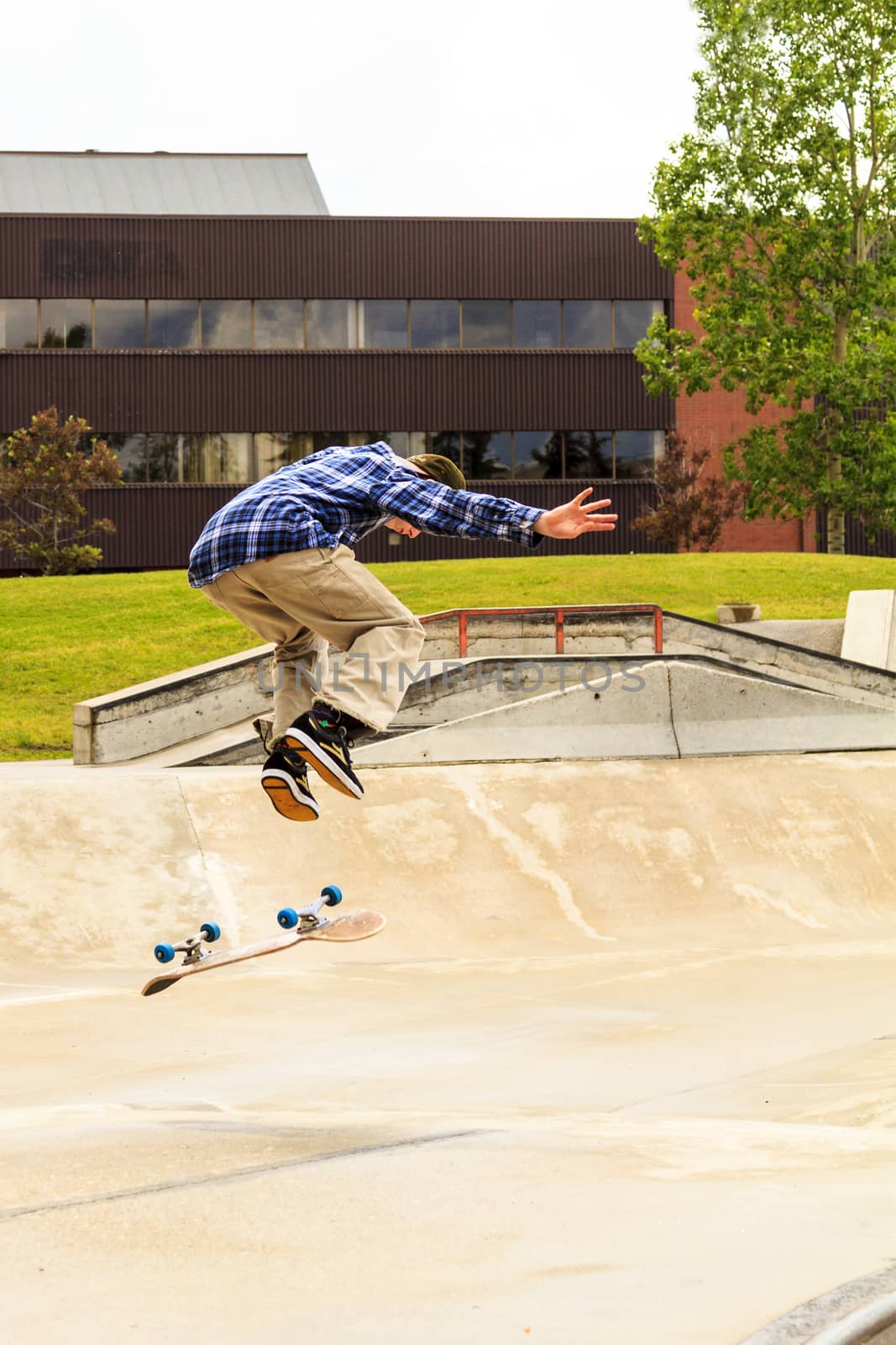 CALGARY, CANADA - JUN 21, 2015: Athletes have a friendly skateboard competition in Calgary. California law requires anyone under the age of 18 to wear a helmet while riding a skateboard.