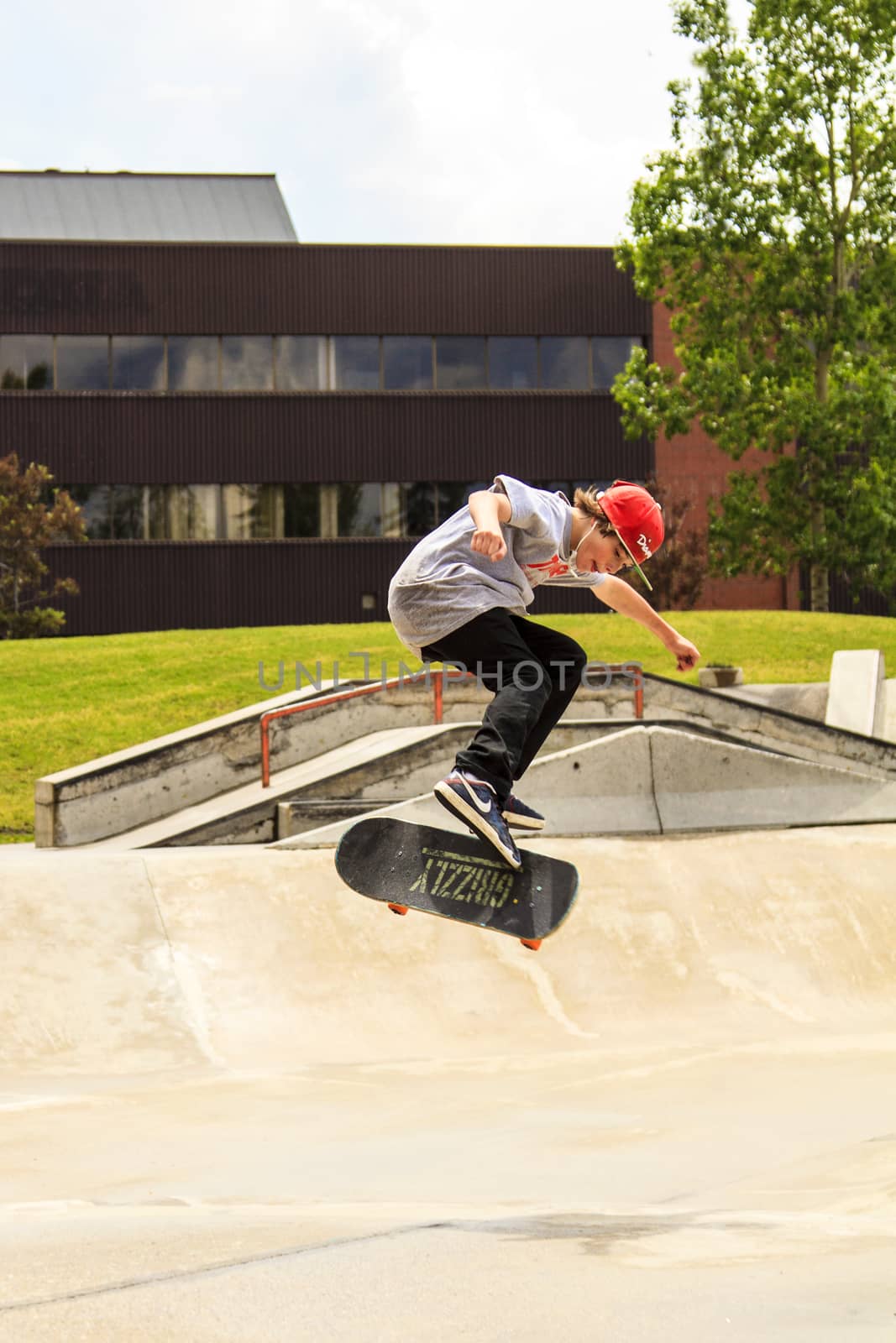 CALGARY, CANADA - JUN 21, 2015: Athletes have a friendly skateboard competition in Calgary. California law requires anyone under the age of 18 to wear a helmet while riding a skateboard.