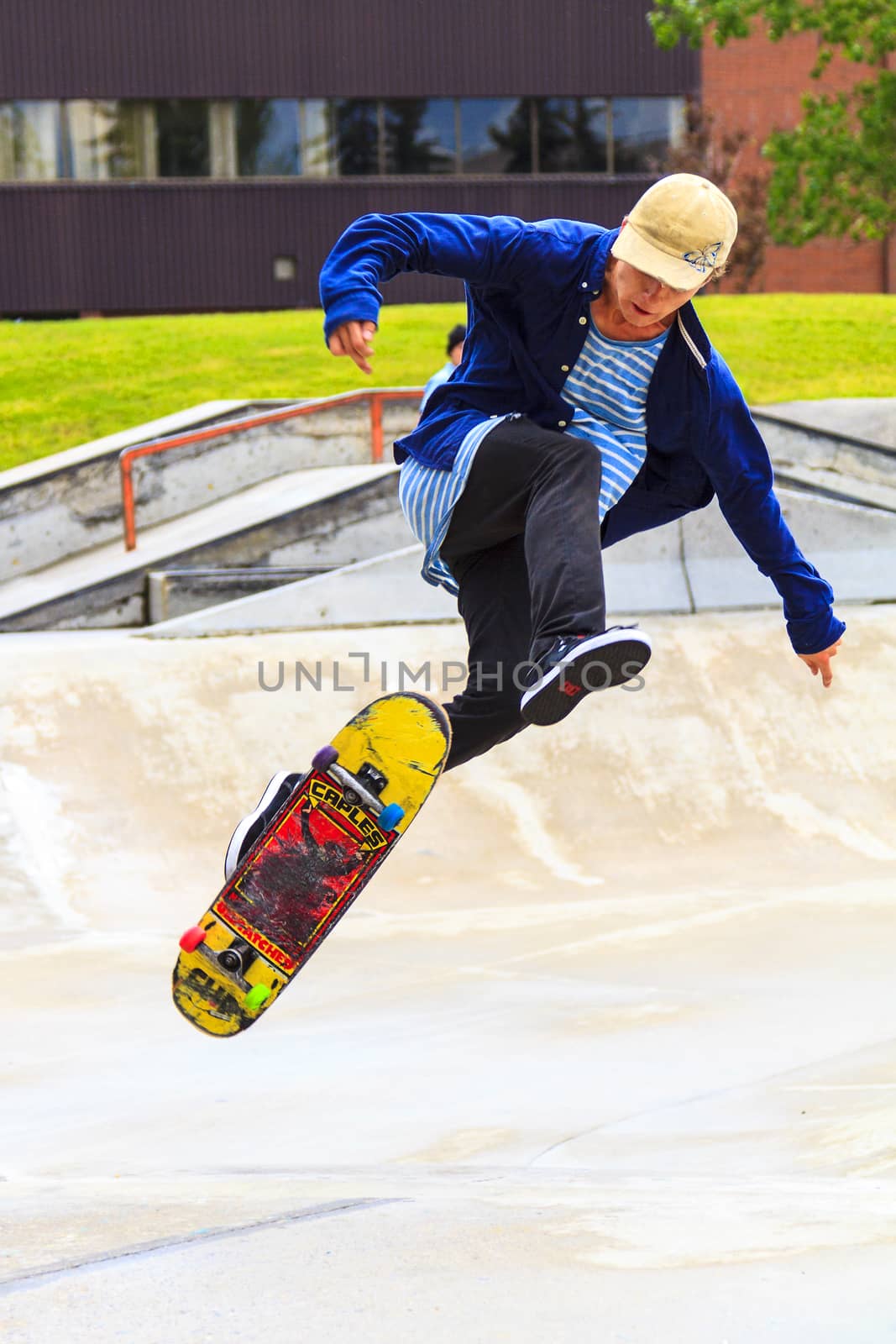 CALGARY, CANADA - JUN 21, 2015: Athletes have a friendly skateboard competition in Calgary. California law requires anyone under the age of 18 to wear a helmet while riding a skateboard.