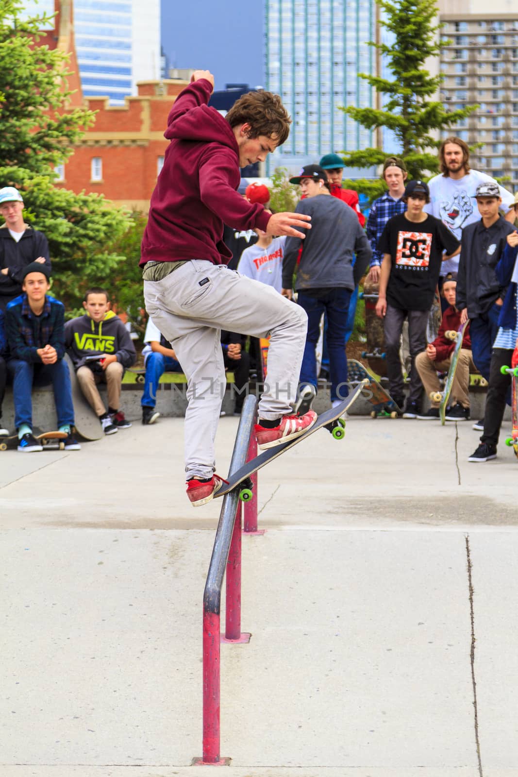 CALGARY, CANADA - JUN 21, 2015: Athletes have a friendly skateboard competition in Calgary. California law requires anyone under the age of 18 to wear a helmet while riding a skateboard.