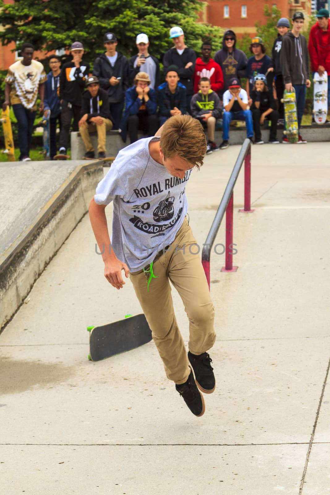 CALGARY, CANADA - JUN 21, 2015: Athletes have a friendly skateboard competition in Calgary. California law requires anyone under the age of 18 to wear a helmet while riding a skateboard.