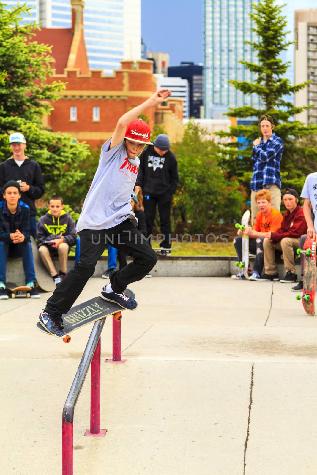 CALGARY, CANADA - JUN 21, 2015: Athletes have a friendly skateboard competition in Calgary. California law requires anyone under the age of 18 to wear a helmet while riding a skateboard.