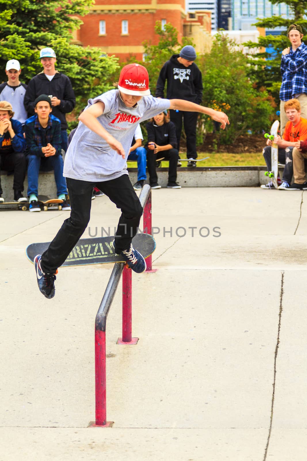 CALGARY, CANADA - JUN 21, 2015: Athletes have a friendly skateboard competition in Calgary. California law requires anyone under the age of 18 to wear a helmet while riding a skateboard.