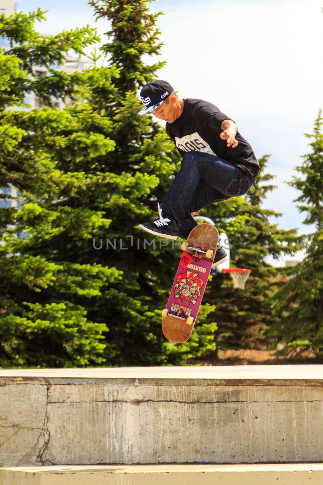 CALGARY, CANADA - JUN 21, 2015: Athletes have a friendly skateboard competition in Calgary. California law requires anyone under the age of 18 to wear a helmet while riding a skateboard.