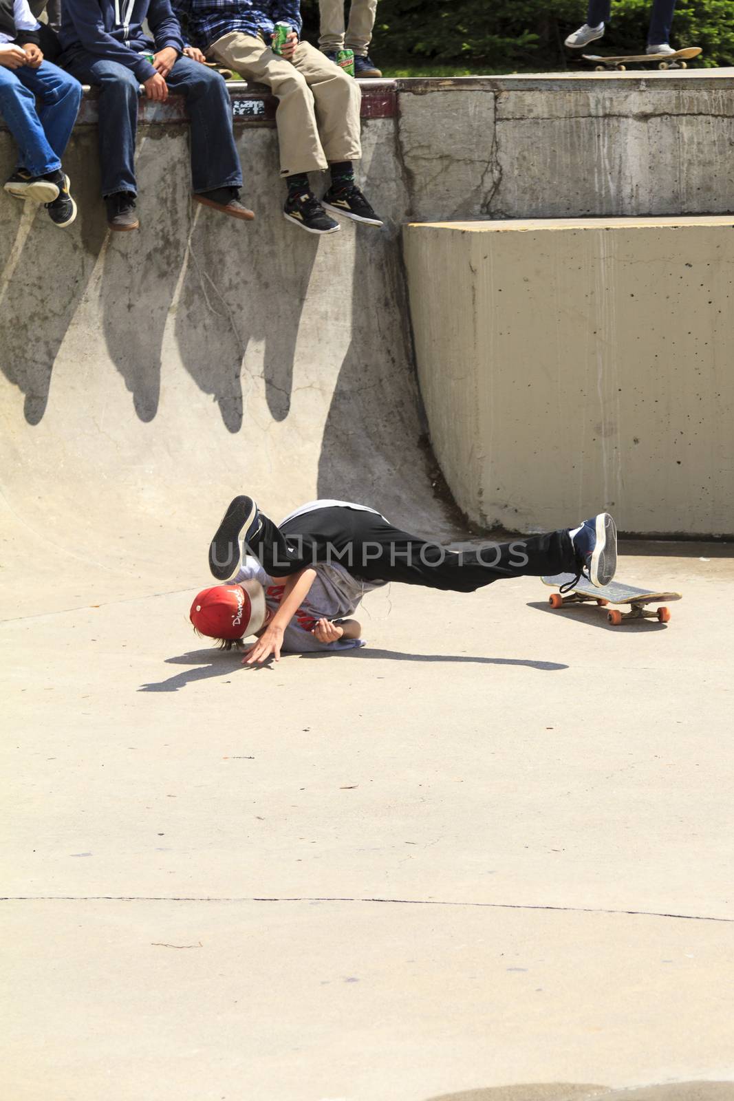 CALGARY, CANADA - JUN 21, 2015: Athletes have a friendly skateboard competition in Calgary. California law requires anyone under the age of 18 to wear a helmet while riding a skateboard.