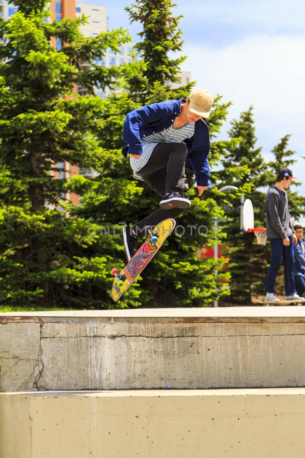 CALGARY, CANADA - JUN 21, 2015: Athletes have a friendly skateboard competition in Calgary. California law requires anyone under the age of 18 to wear a helmet while riding a skateboard.