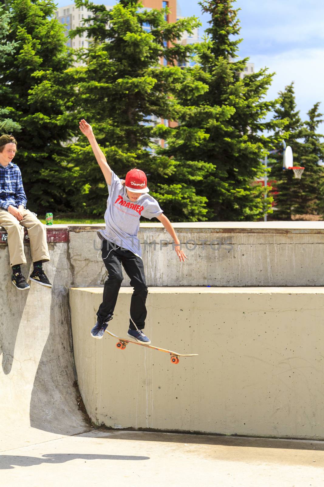 CALGARY, CANADA - JUN 21, 2015: Athletes have a friendly skateboard competition in Calgary. California law requires anyone under the age of 18 to wear a helmet while riding a skateboard.