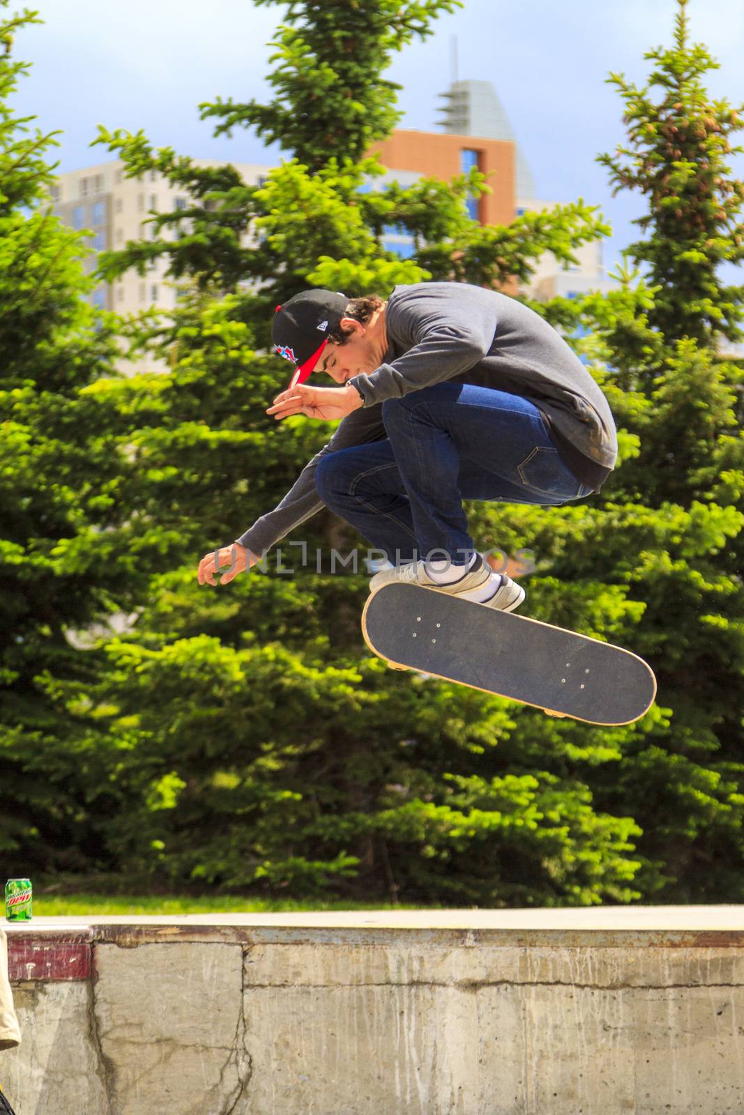 CALGARY, CANADA - JUN 21, 2015: Athletes have a friendly skateboard competition in Calgary. California law requires anyone under the age of 18 to wear a helmet while riding a skateboard.