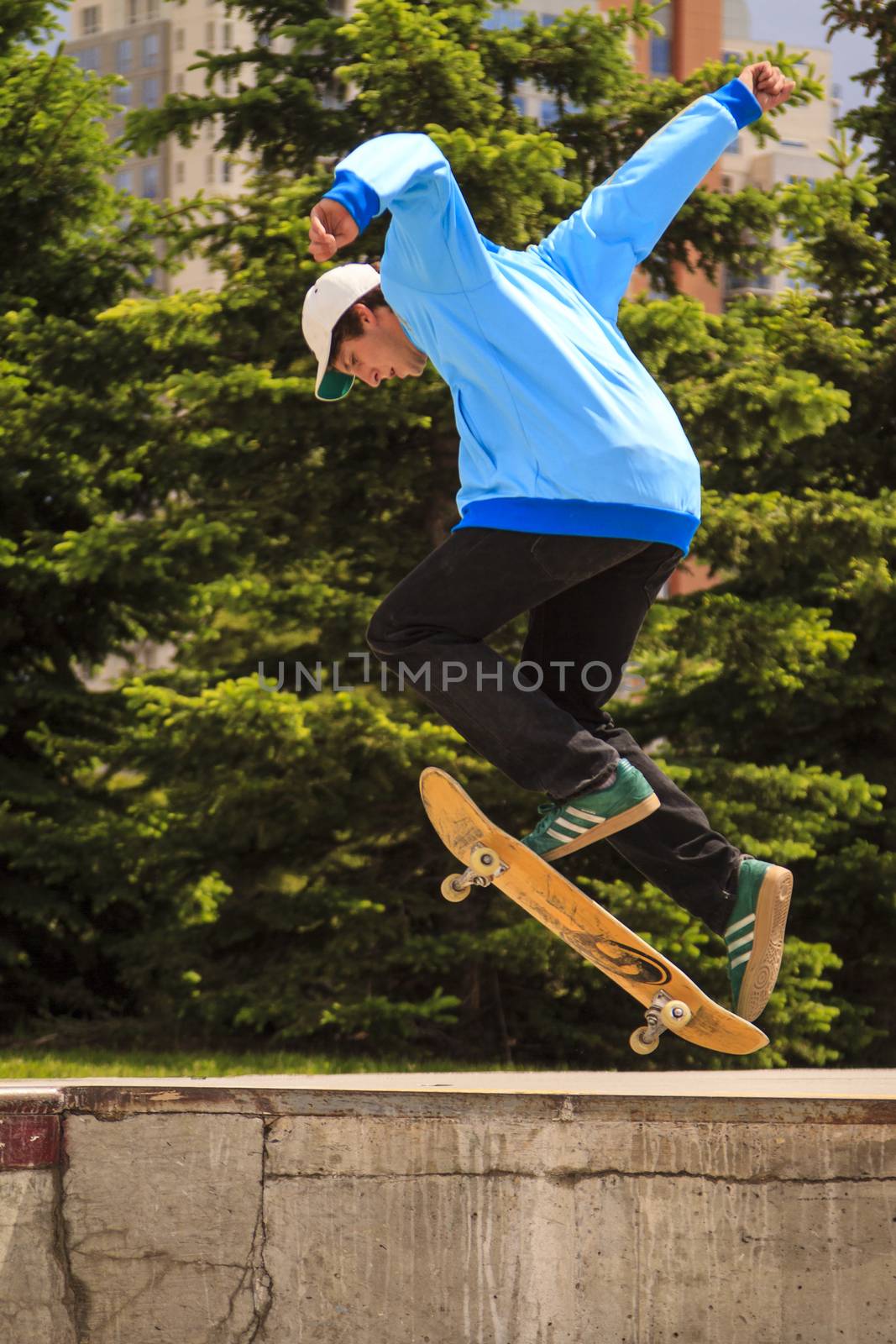 CALGARY, CANADA - JUN 21, 2015: Athletes have a friendly skateboard competition in Calgary. California law requires anyone under the age of 18 to wear a helmet while riding a skateboard.