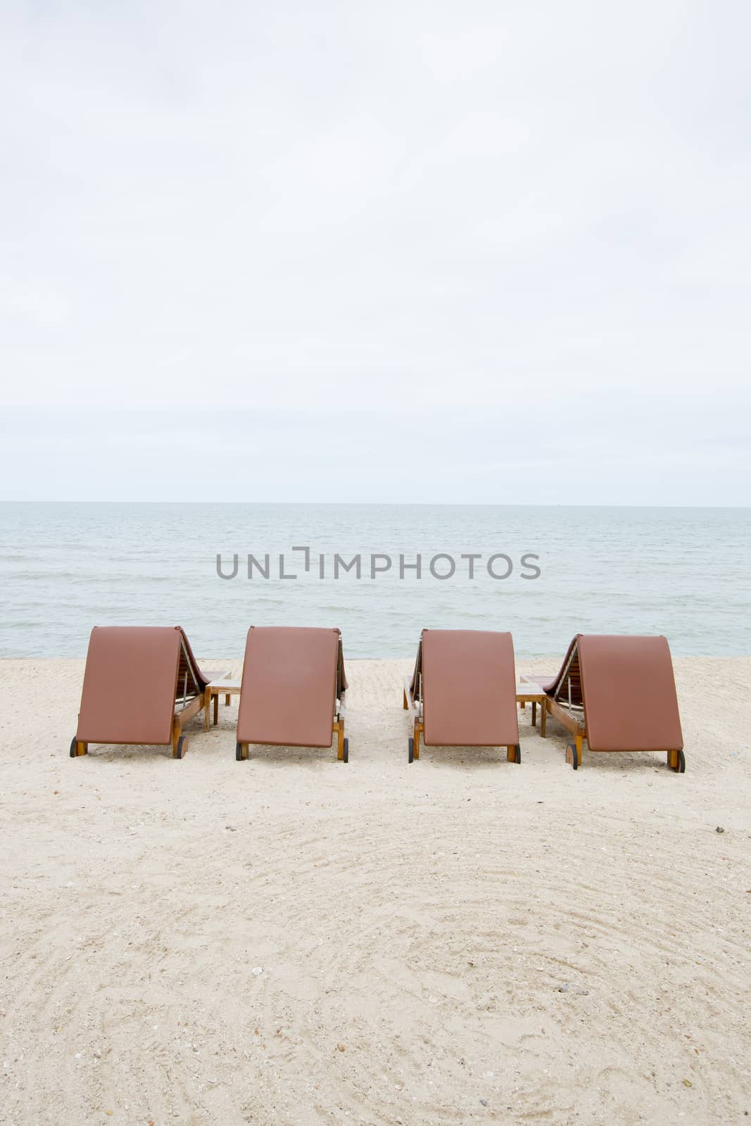 Beach chair on sand beach. Concept for rest, relaxation, holidays, spa, resort.