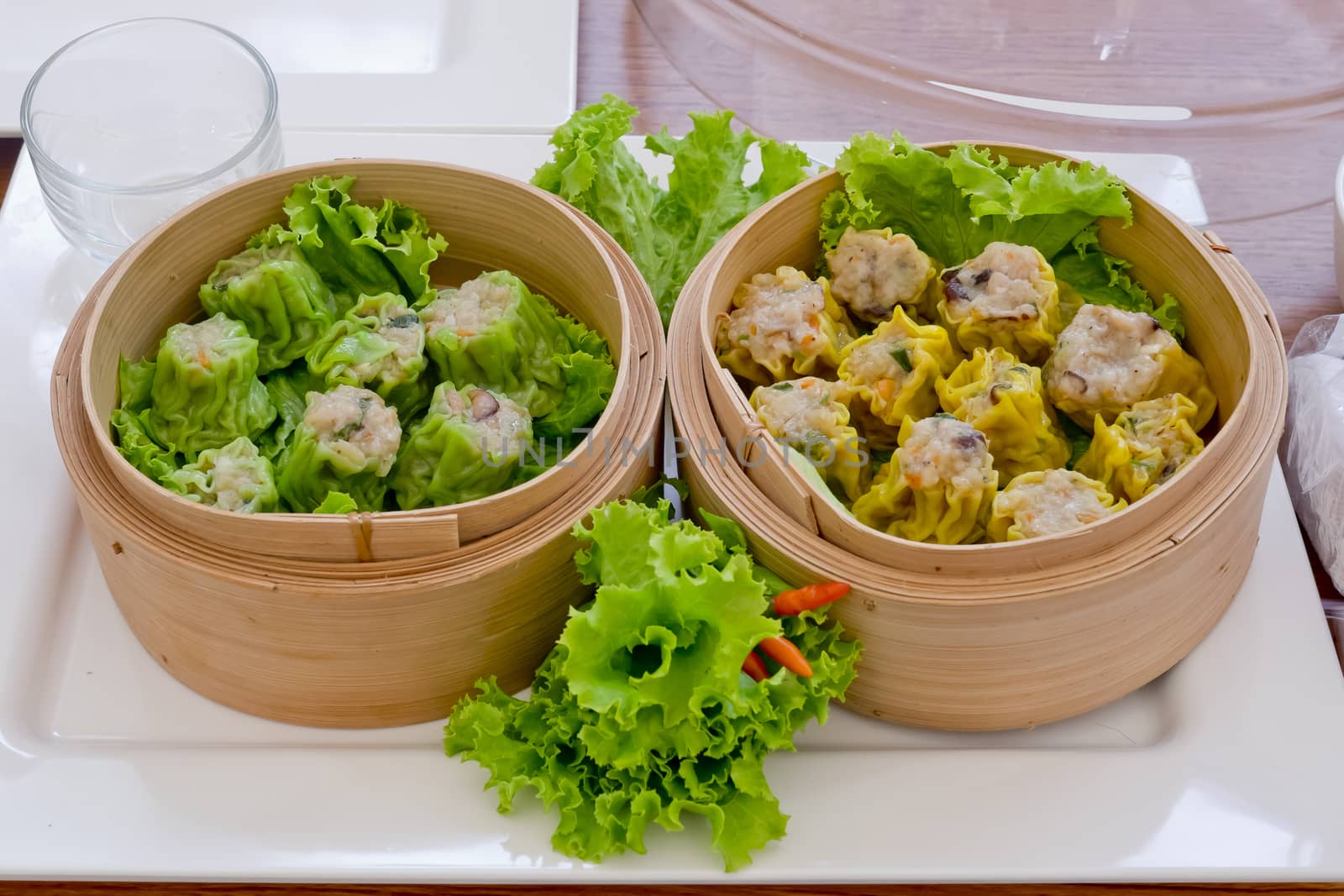 Kind of chinese snacks, Chinese steamed dimsum in bamboo with green and yellow colors.