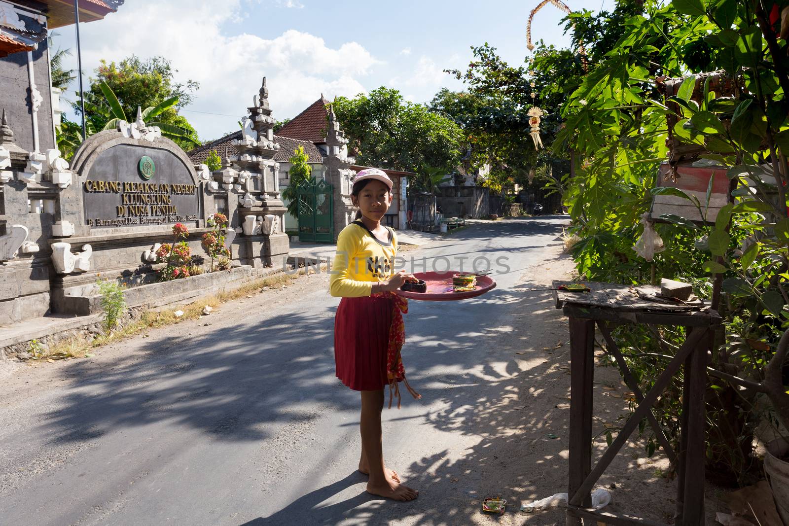 BALI, NUSA PENIDA ISLAND, INDONESIA - JULY 28.2015: Unidentified balinese indonesian girl bring offerings of fruits and gifts to the home temple. Nusa Penida July 27. 2015 Indonesia