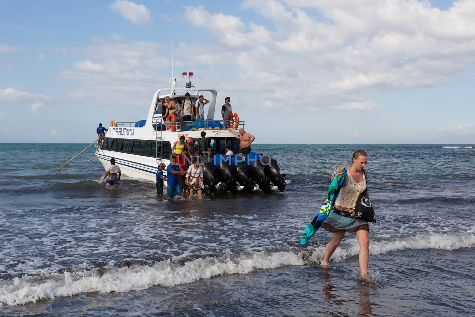 BALI, SANUR, INDONESIA - JULY 31.2015: Maruti Speed Boat, taking 45 min from Sanur to Nusa Penida. Passengers must enter to the boat directly from the sea. Sanur July 31. 2015 Indonesia