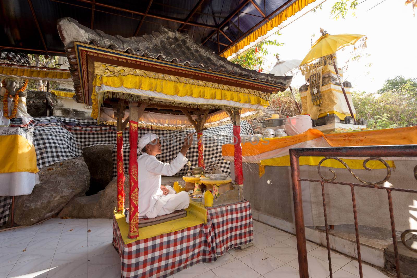 BALI, NUSA PENIDA ISLAND, INDONESIA - JULY 28.2015: Unidentified Balinese monk at praying ceremony in Goa Giri Putri temple. Nusa Penida July 27. 2015 Indonesia