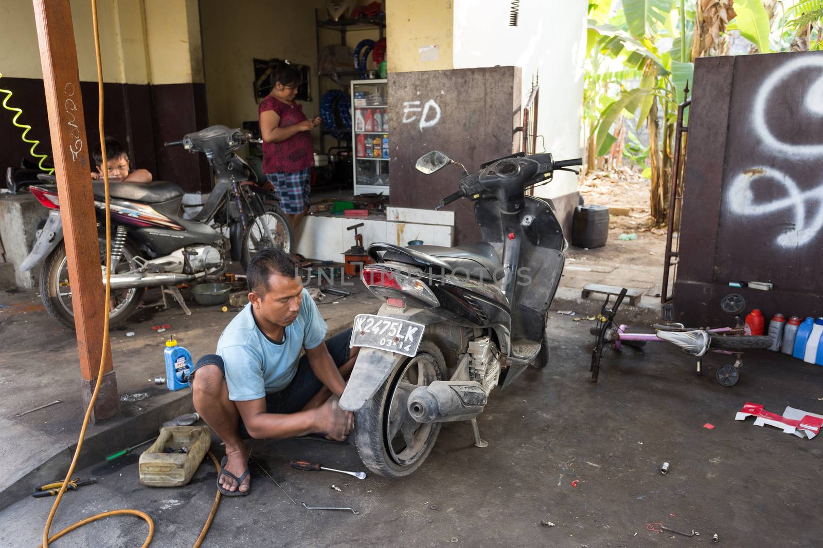 BALI, NUSA PENIDA ISLAND, INDONESIA - JULY 28.2015: Street motorbike service in Toyapakeh. Nusa Penida July 27. 2015 Indonesia