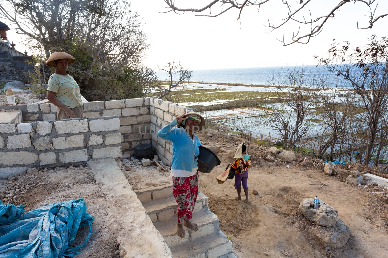 BALI, NUSA PENIDA ISLAND, INDONESIA - JULY 28.2015: Unidentified balinese indonesian woman with basket with seaweed. Nusa Penida July 27. 2015 Indonesia