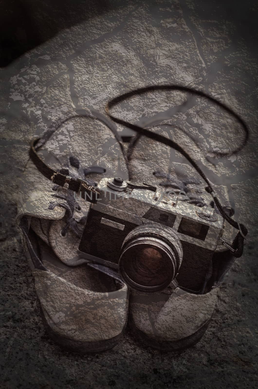 Vintage film camera on shoes with texture overlay  by pixbox77