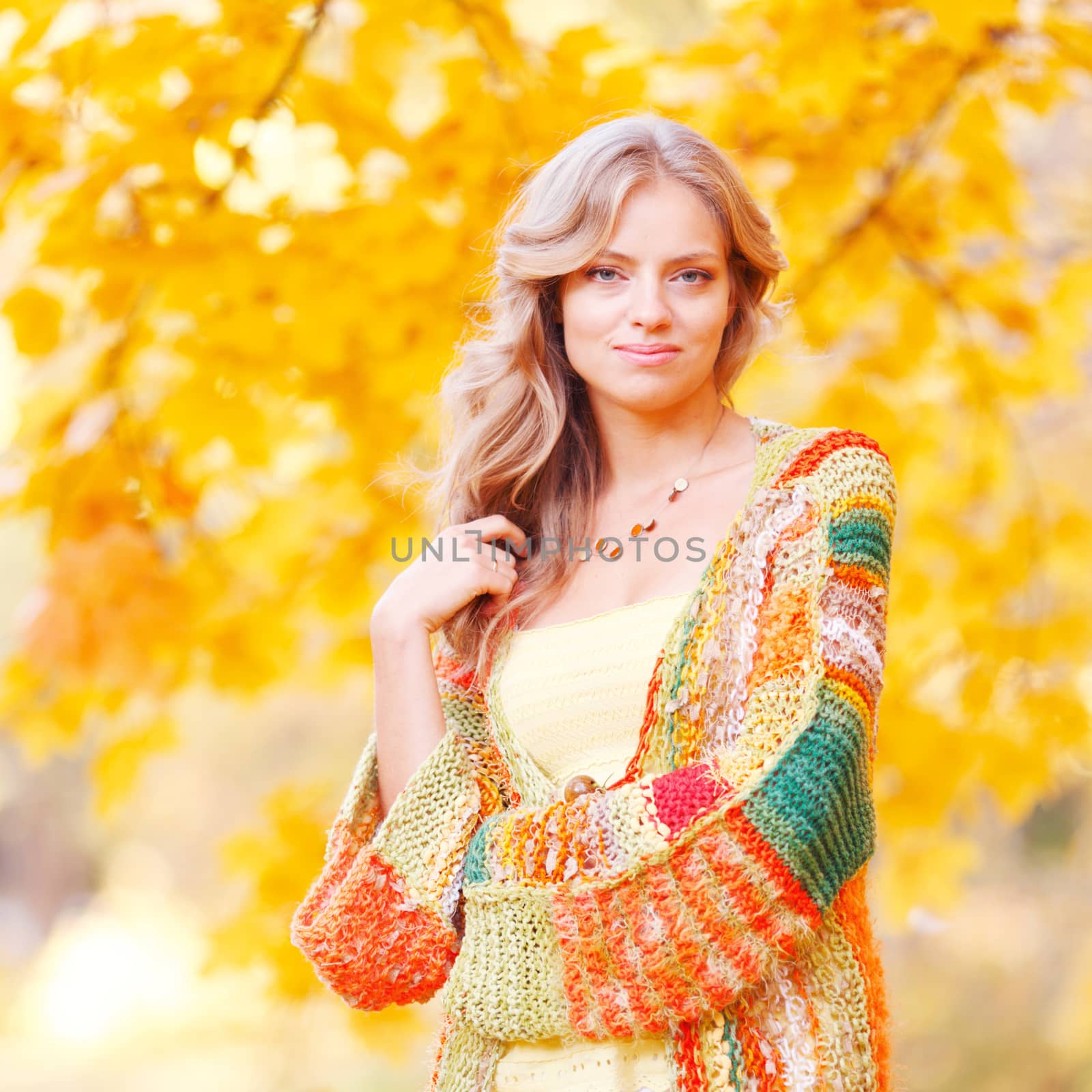 Beautiful blond woman posing in autumn park