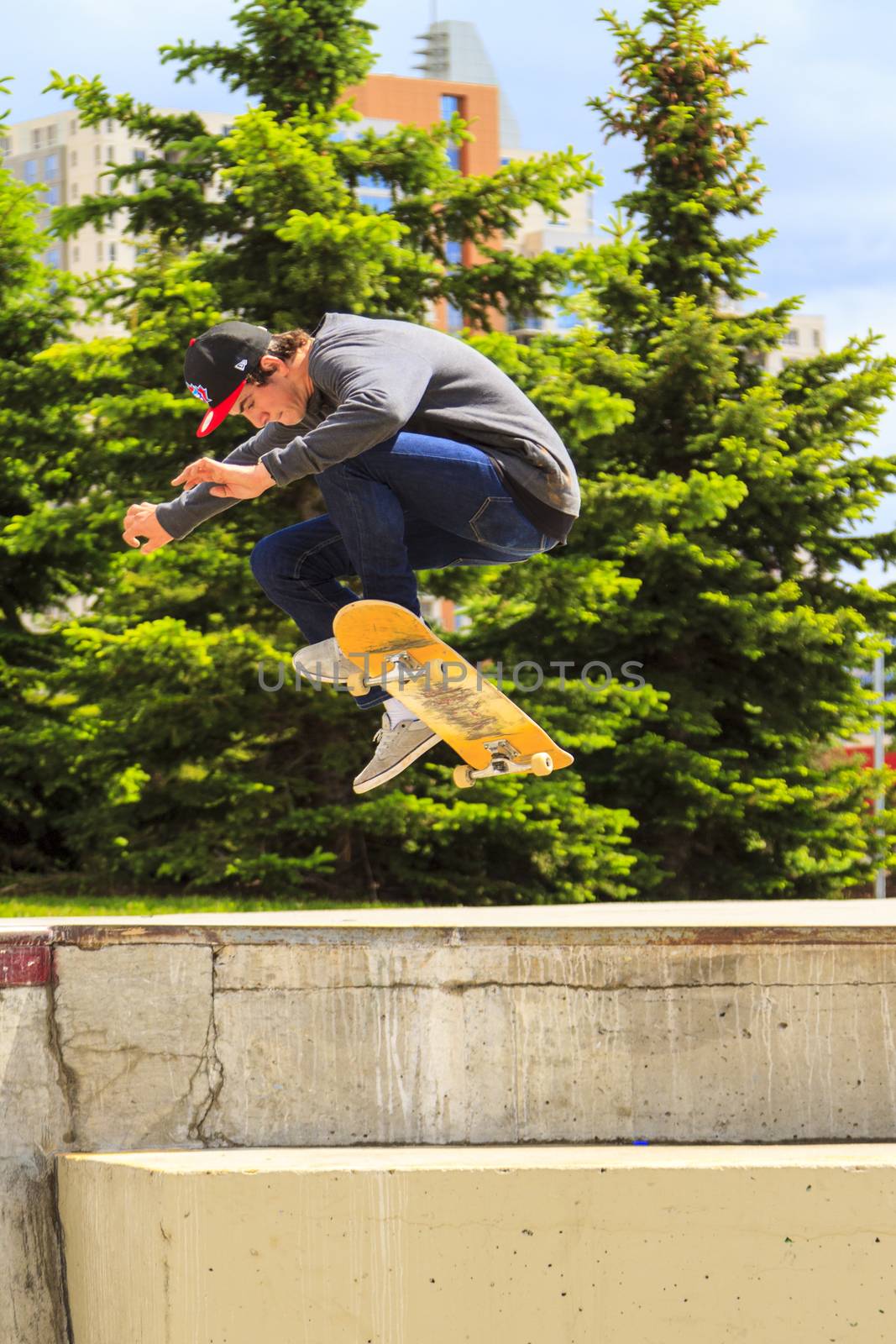 CALGARY, CANADA - JUN 21, 2015: Athletes have a friendly skateboard competition in Calgary. California law requires anyone under the age of 18 to wear a helmet while riding a skateboard.