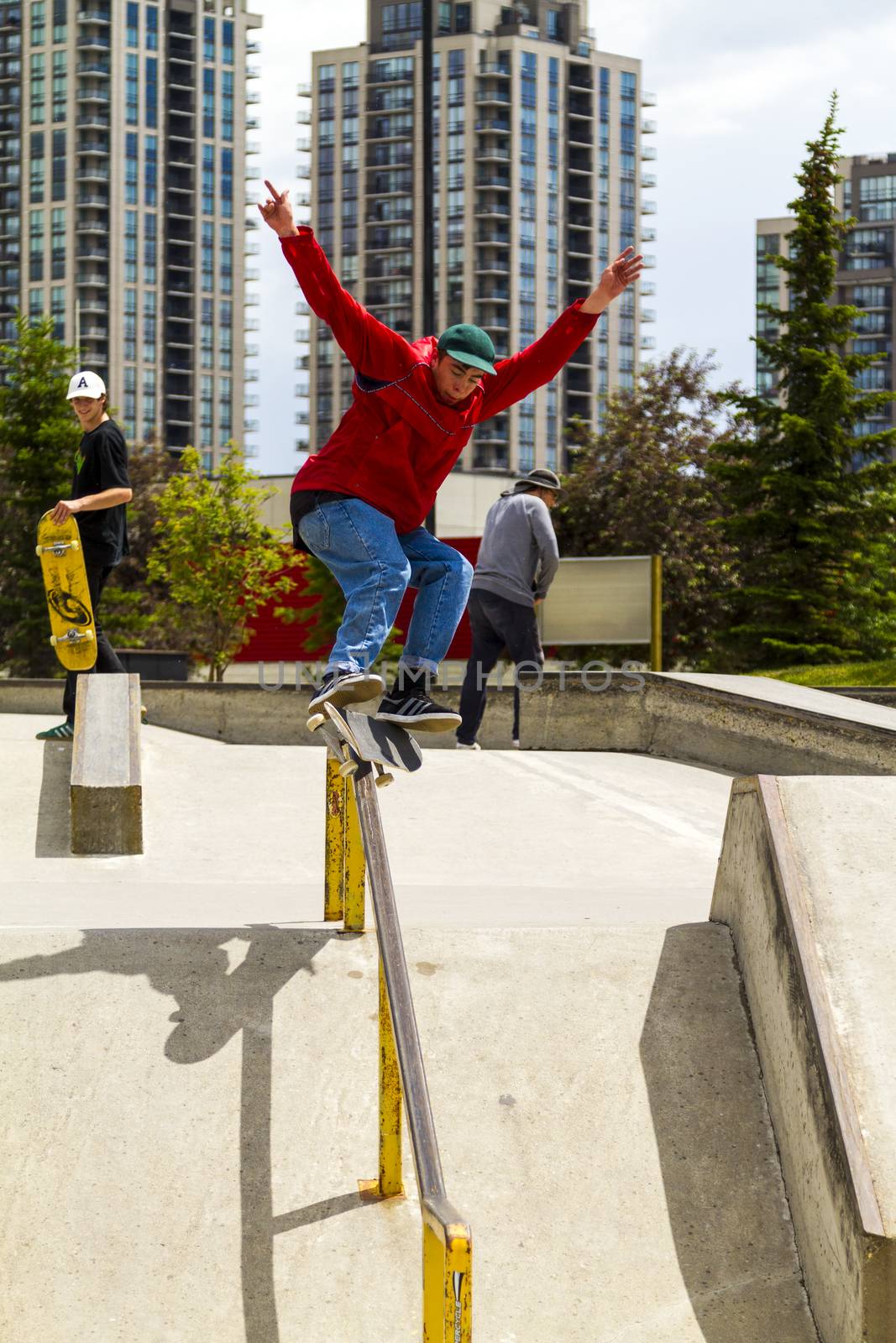 CALGARY, CANADA - JUN 21, 2015: Athletes have a friendly skateboard competition in Calgary. California law requires anyone under the age of 18 to wear a helmet while riding a skateboard.