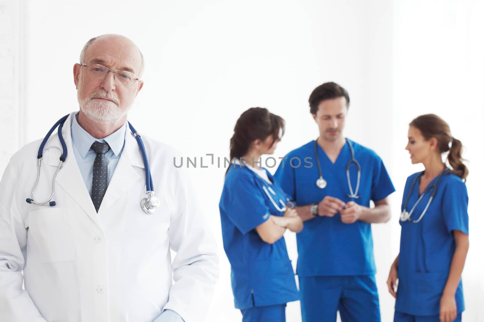 Professional team of doctors and nurses on white background