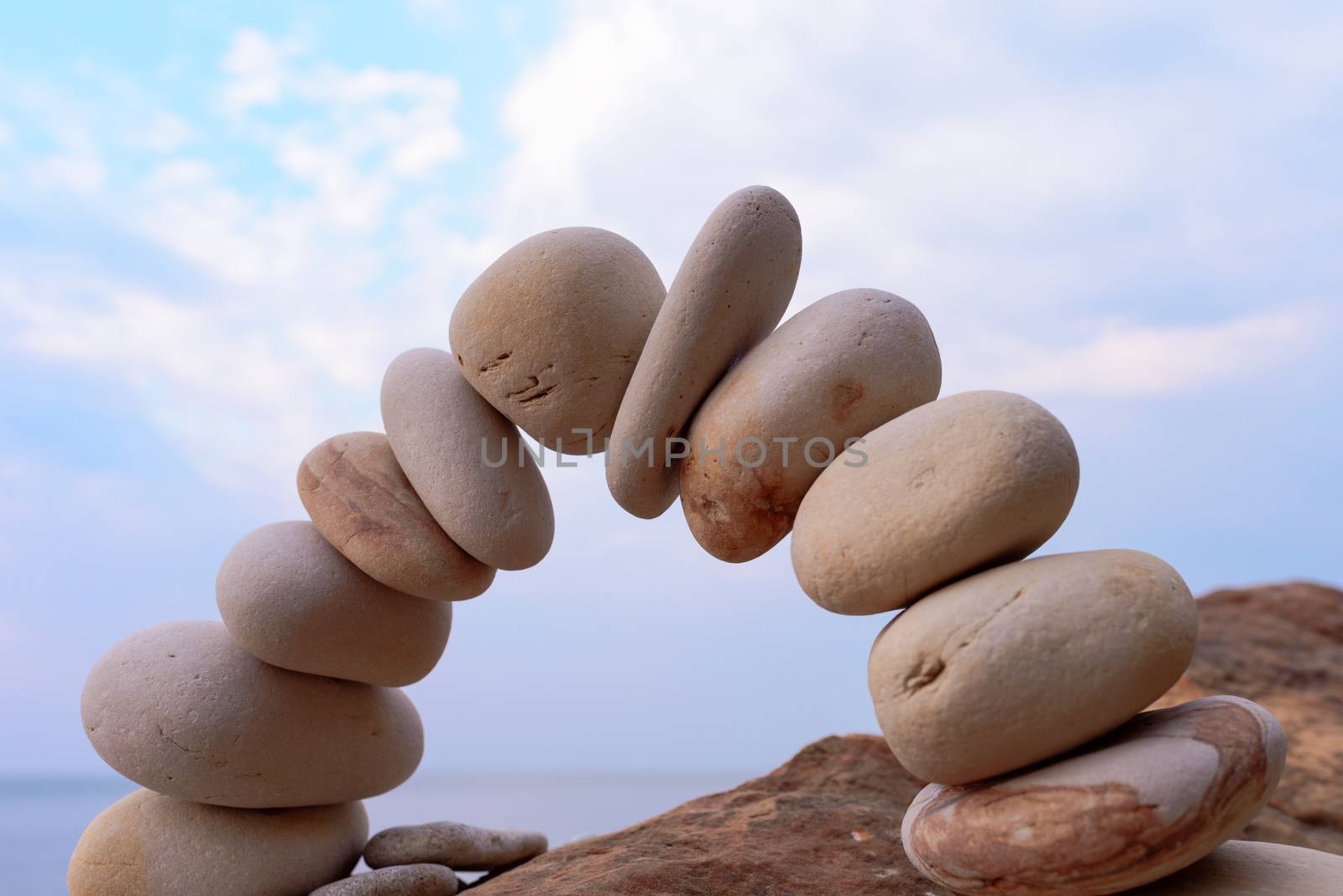 Pebbles in the form of a arch on the coast