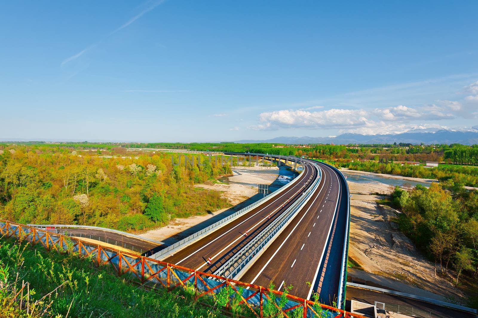 The Modern Highway in Piedmont on the Background of Snow-capped Alps, Italy