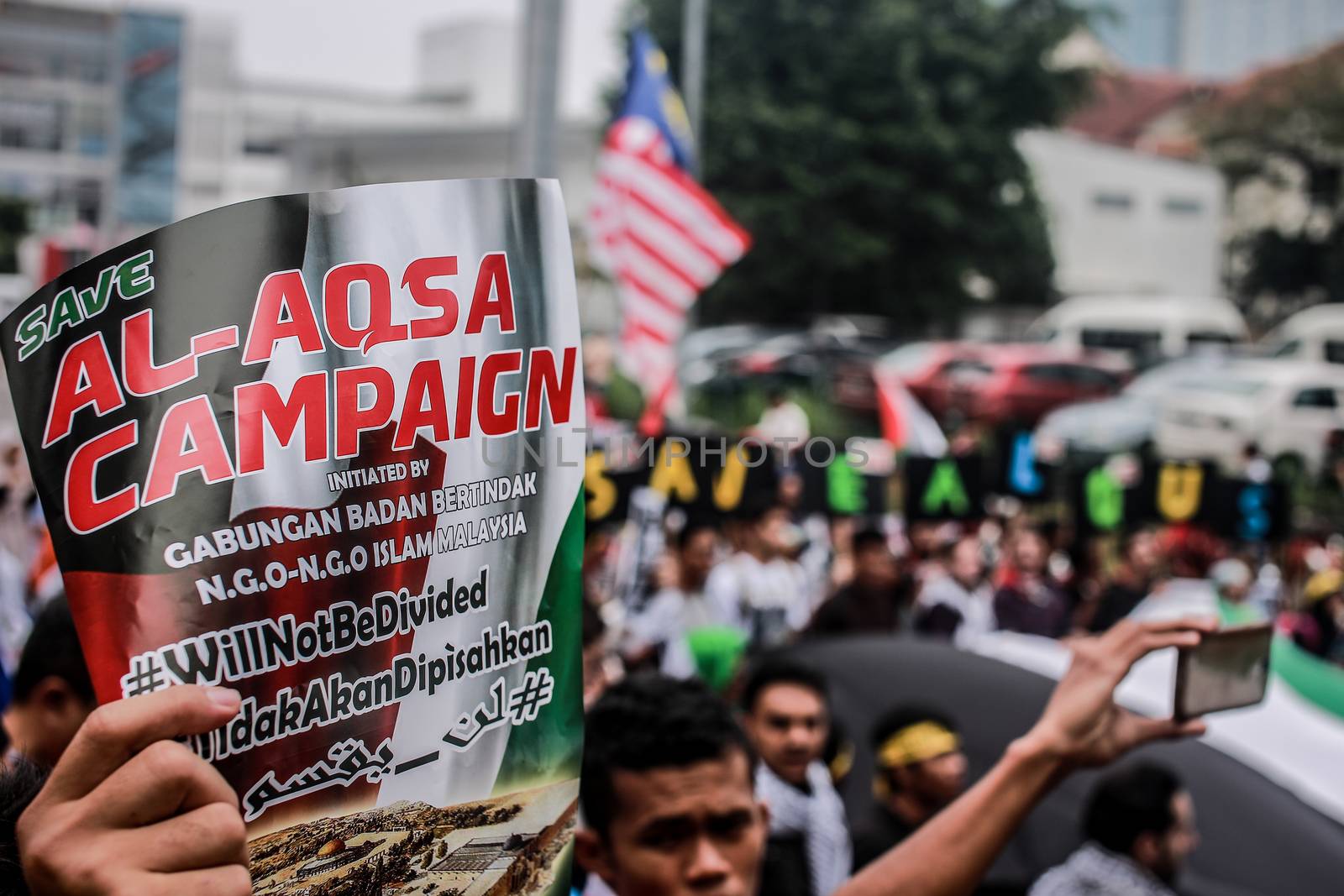 MALAYSIA, Kuala Lumpur: A close up of a sign calling for justice at a rally in front of US Embassy in Kuala Lumpur, Malaysia on October 2, 2015. Protesters urge Americans to act against its ally Israel following clashes at Al-Aqsa mosque, between Israeli security forces and Palestinians Muslims.These pictures show hundreds of people holding signs, banners and waving flags as they parade in the Malaysian capital.