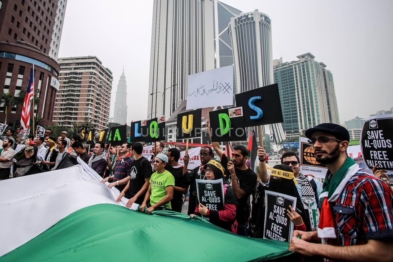 MALAYSIA, Kuala Lumpur: Protesters hold up signs and wave flags at a rally in front of US Embassy in Kuala Lumpur, Malaysia on October 2, 2015. Protesters urge Americans to act against its ally Israel following clashes at Al-Aqsa mosque, between Israeli security forces and Palestinians Muslims.These pictures show hundreds of people holding signs, banners and waving flags as they parade in the Malaysian capital.