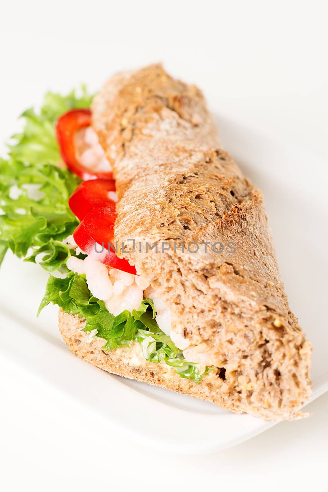 Prawn sandwich on white plate vertical angled by Nanisimova