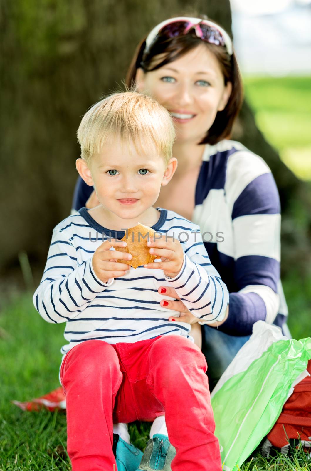 Lovely portrait of a mother and son outdoor at picnic by Nanisimova