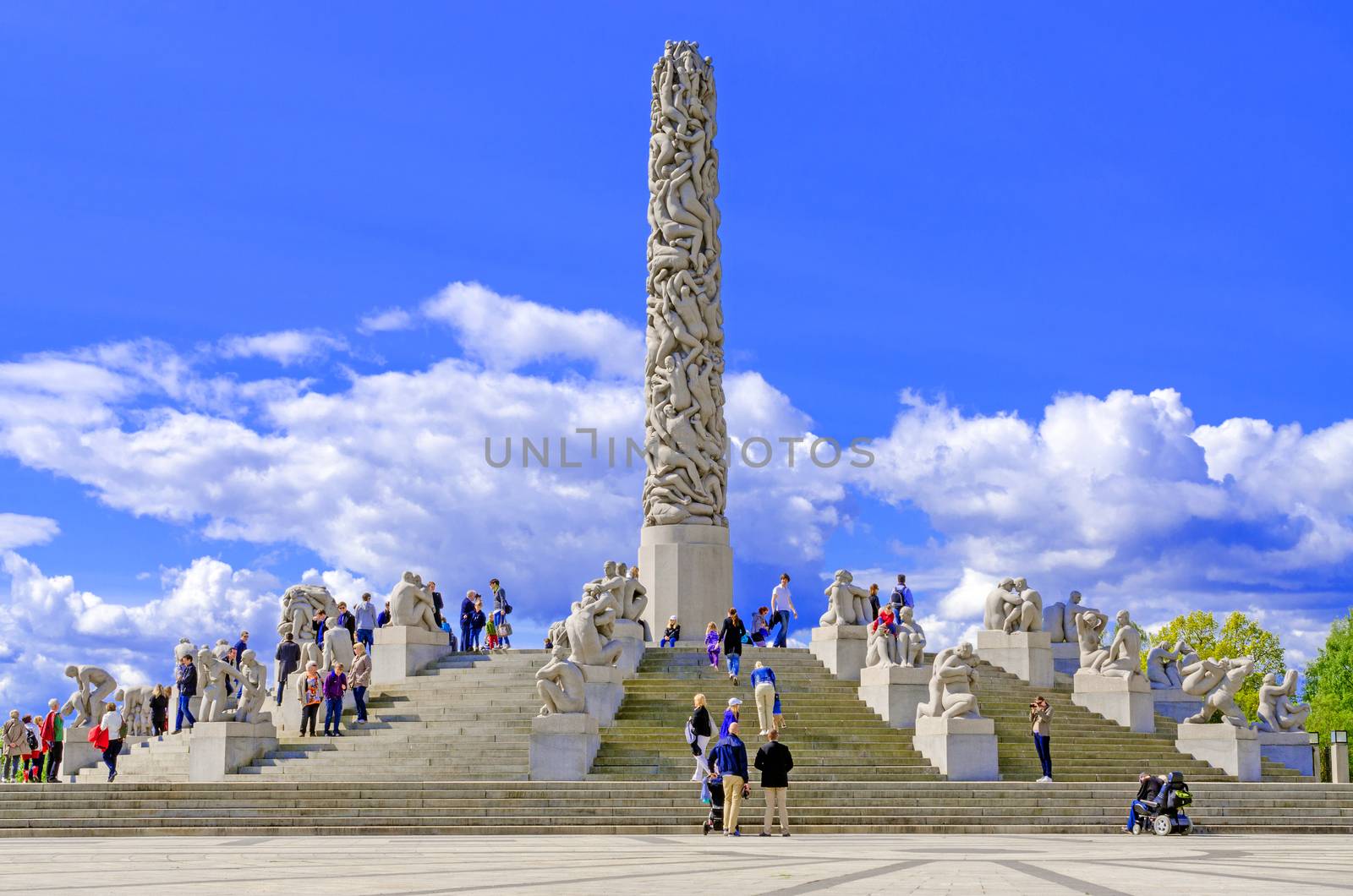 Statues in Vigeland park in Oslo centerpiece and sky by Nanisimova