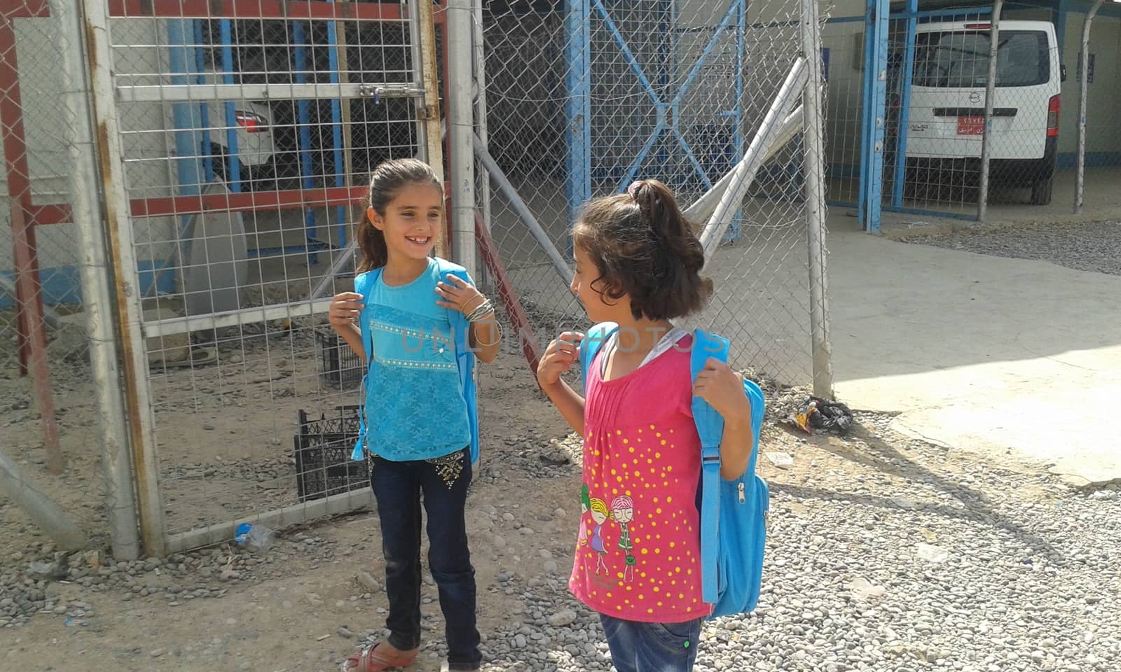 IRAQ, Kurdistan: Two young girls prepare for school in Kawergosk camp in Kurdistan on October 1, 2015. Syrian refugee students attend school on the second day of new year study.Thousands of refugees have been forced to flee Syria as a result of the civil war which has been raging for more than four years.  
