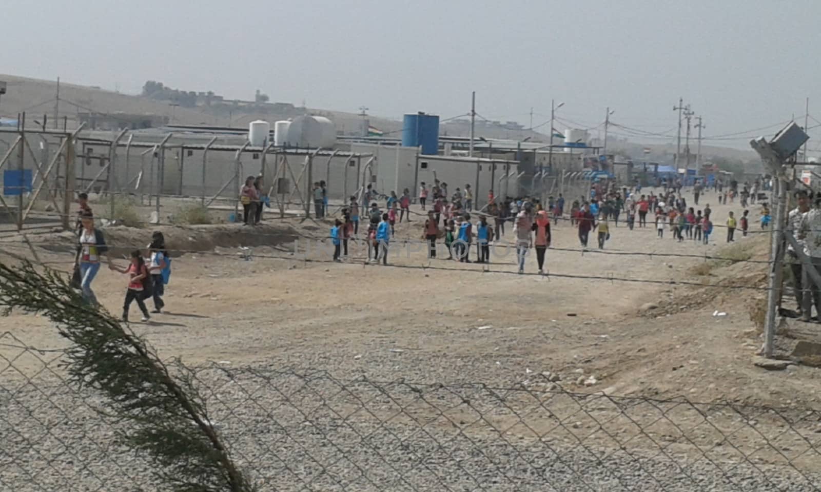 IRAQ, Kurdistan: A wide shot of children walking to school in the Kawergosk refugee camp in Kurdistan on October 1, 2015. Syrian refugee students attend school on the second day of new year study.Thousands of refugees have been forced to flee Syria as a result of the civil war which has been raging for more than four years.  