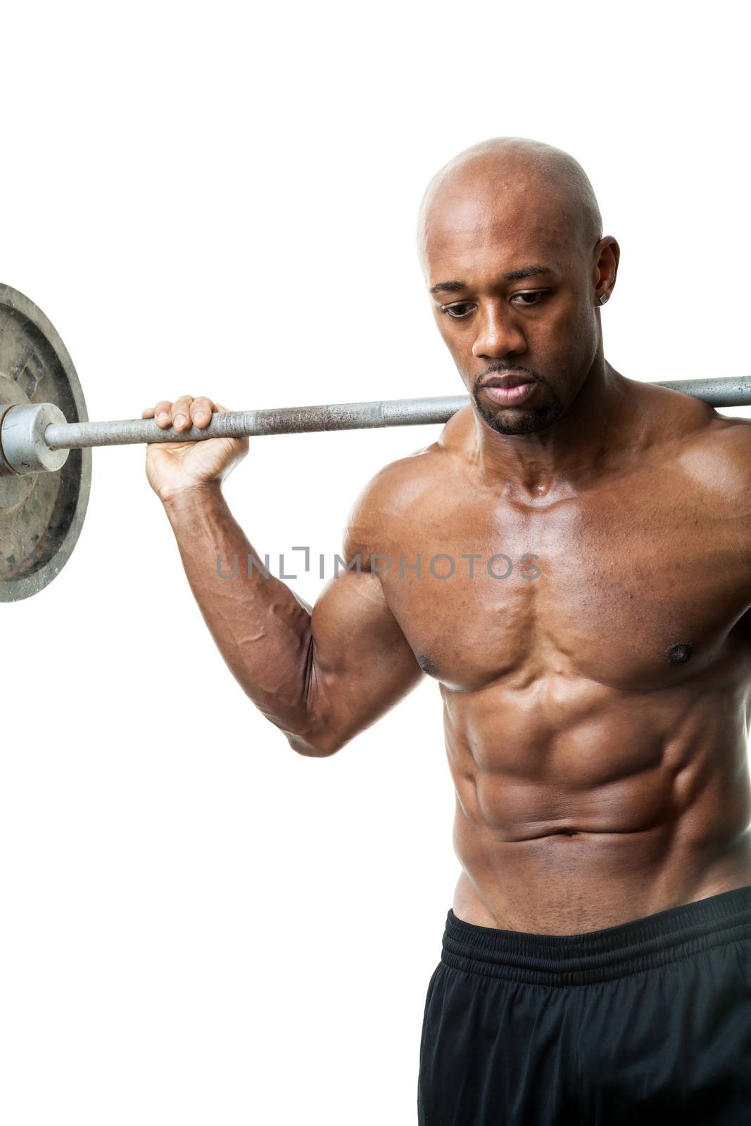 Toned and ripped lean muscle fitness man lifting weights isolated over a white background.